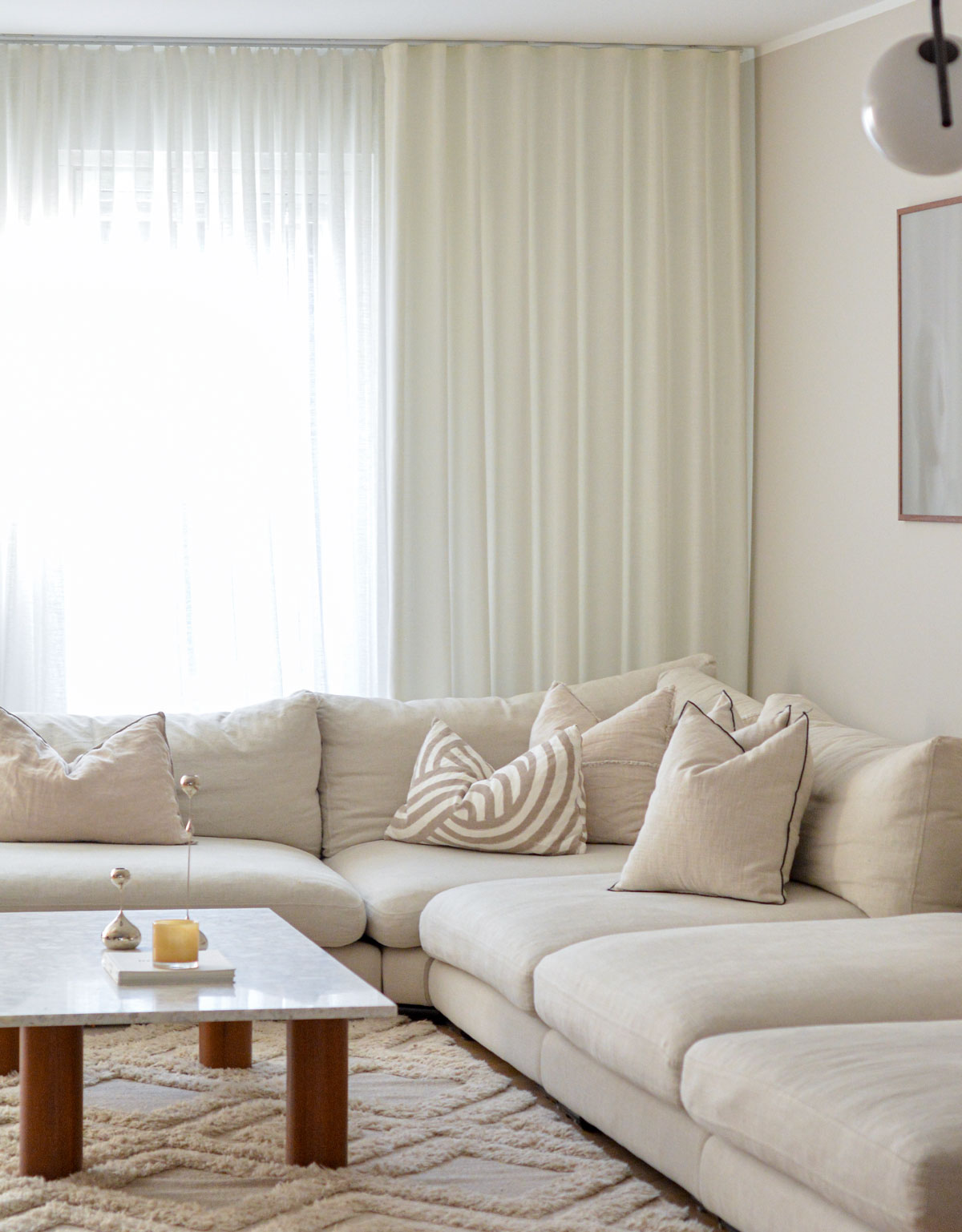 White curtains behind a sofa