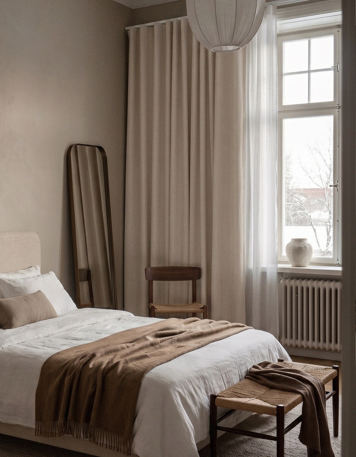 Room-darkening light beige curtains in a bedroom